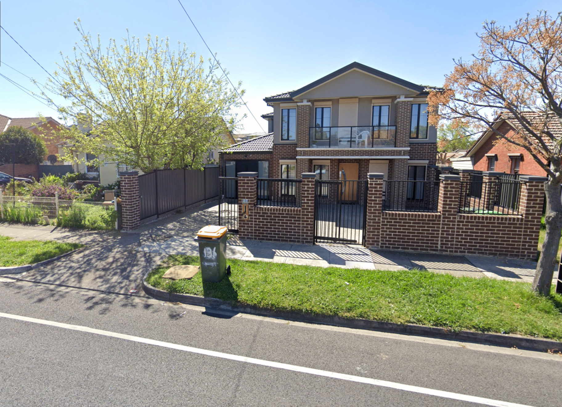 Modern double-storey brick home in Preston with secure fencing and gated driveway