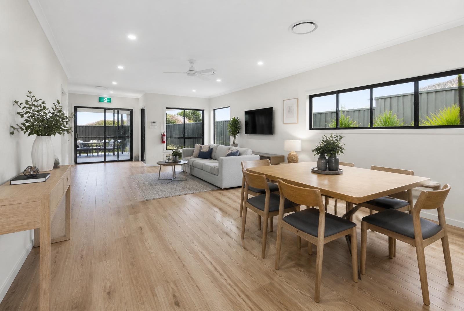Bright open-plan living and dining area with wide clear pathways and natural light